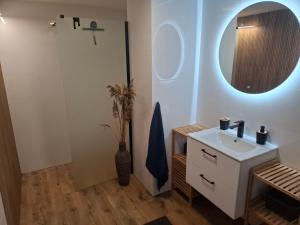 a bathroom with a sink and a mirror at Dom nad Morzem 79 in Stegna +10 photos