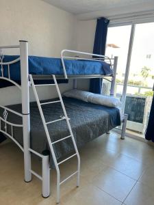 two bunk beds in a room with a window at Comfortable apartment with pool near beaches in Acapulco +19 photos