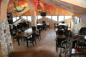 a dining room with wooden tables and chairs at Hotel Laguna in Vama Veche