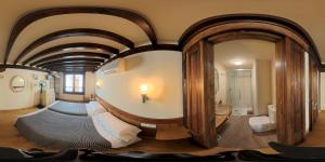 a bedroom with a large mirror in a room at Hostería La Antigua in Potes