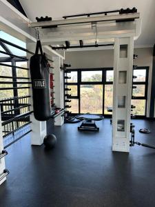 a gym with a punching bag hanging from the ceiling at Midrand Stylish 1Bedroom Escape in Midrand