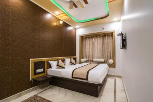 a bedroom with a bed in a room at Hotel Saffron Diamond in Jaisalmer