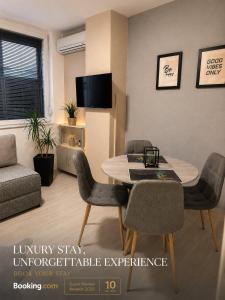 a living room with a dining room table and chairs at NOA Luxury Apartment in Bitola
