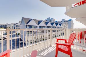 a balcony with two red chairs and a white fence at Bonita Beach Hotel in Ocean City