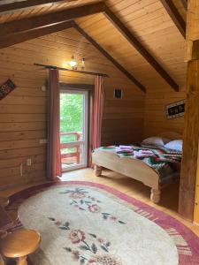 a bedroom with a bed in a room with a window at Ребровач in Tatariv