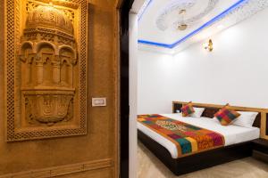 a bedroom with a bed and a door to a room at Hotel Saffron Diamond in Jaisalmer +5 photos