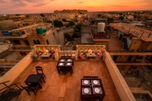 a view from the top of a building with tables and chairs at Hotel Saffron Diamond in Jaisalmer