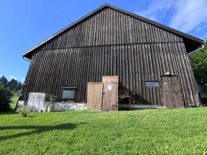 a large barn with two doors on the side of it at Genau So - Schäferwagen in Maierhöfen
