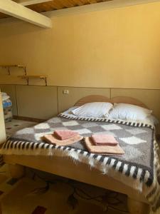 a bed in a room with towels on it at Ребровач in Tatariv