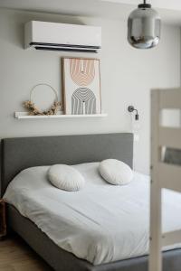 a bedroom with a bed with two pillows on it at Vakantiewoning Spoor 23 in Borgloon