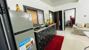 a kitchen with a refrigerator and a living room at Dar Calme Takad in Ben Guemoud +11 photos