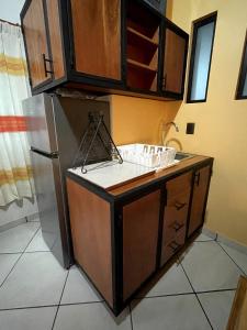 a kitchen with a sink and a refrigerator at Casa María Bonita - Loft Bonito in La Cal