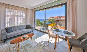 a living room with a couch and a table at Hemera Suite in Kaş