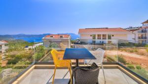 a table and chairs on a balcony with a view at Hemera Suite in Kaş