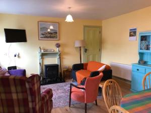 a living room with a couch and a fireplace at Culoort Cottage - Malin Head in Malin Head +21 photos