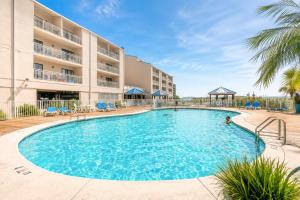 a large swimming pool in front of a hotel at Sugar Beach153- 4 pools beachfront in Gulf Shores