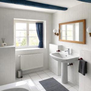 a white bathroom with a sink and a mirror at Gästehaus Am Hafen 7 Glückstadt in Glückstadt