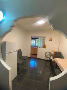 a living room with a staircase and a kitchen at Apartament Maria in Năvodari