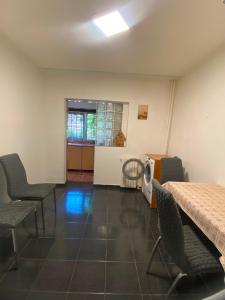 an empty room with chairs and a table and a room with a table at Apartament Maria in Năvodari