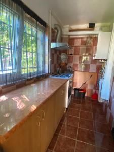 a kitchen with a counter top and a stove at Apartament Maria in Năvodari