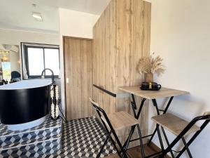 a bathroom with a tub and a table and chairs at Studio cosy avec balnéo et climatisation in Albi +3 photos