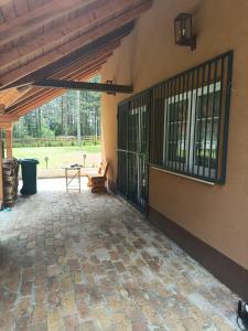 a screened in porch with a table and a patio at Planinska Kuća Nišićka visoravan in Ilijaš +6 photos