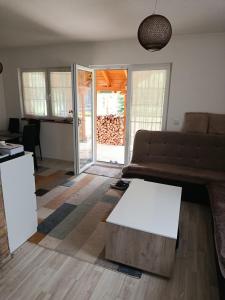 a living room with a couch and a coffee table at Planinska Kuća Nišićka visoravan in Ilijaš