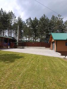 a park with a playground and a building with a green roof at Planinska Kuća Nišićka visoravan in Ilijaš