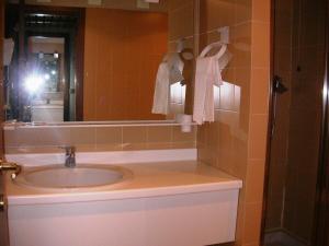 a person taking a picture of a bathroom with a sink at Appartamento in Hotel Residence Universo in Pré-Saint-Didier