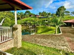 a view of a garden from the porch of a house at Hosteria Arizona in Puyo