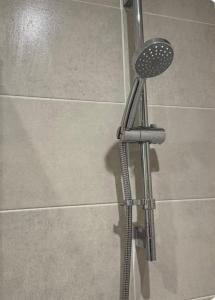 a shower in a bathroom with a shower head at Classic Foenix Home in Milton Keynes