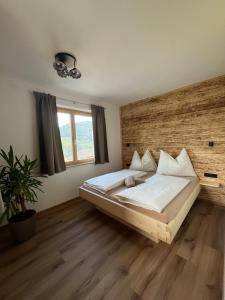 a bedroom with a large bed with a wooden headboard at Haus Anneliese in Gröbming