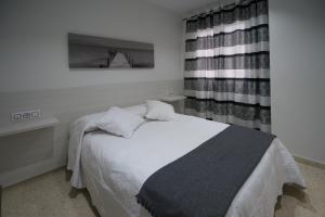 Postel nebo postele na pokoji v ubytování Apartamentos Ortega
