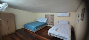 a hospital room with two beds and a window at Gold house apartment in Vientiane