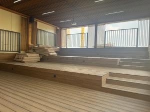 an empty room with wooden floors and windows at NRG BI Sado in Salor Bekati +2 photos