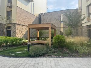 a wooden bench sitting in front of a building at NRG BI Sado in Salor Bekati