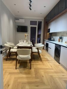 a kitchen and dining room with a table and chairs at NRG BI Sado in Salor Bekati
