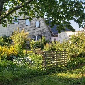 a garden with a wooden fence in front of a house at Eifelhaus in Hürtgenwald