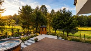 a backyard with a hot tub and a gazebo at DARESTATE - dom rodzinny in Zgon