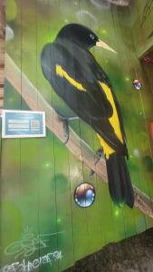 a painting of a black and yellow bird on a table at Hospedaria Ponta da Flexeira in Belém