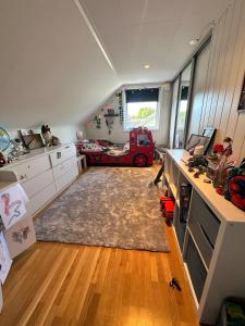 a room with a kitchen with a red truck in it at hus in Moss