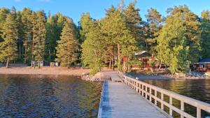 a wooden bridge over a body of water at Saimaan Rantavilla Zebra in Imatra