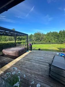 a wooden deck with a bed on top of it at hus in Moss