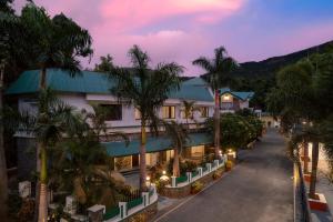 an aerial view of a hotel with palm trees at Velvet Resort Khandala in Khandāla