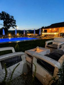 a patio with a table and chairs next to a pool at Katerina's Relaxing Apartment in Sarandë