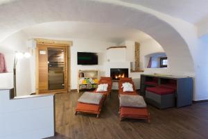 a living room with four chairs and a fireplace at Ferienwohnung Kagerer in Gutau