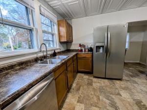 a kitchen with a stainless steel refrigerator and a sink at Hook Wine and Sinker in Marion