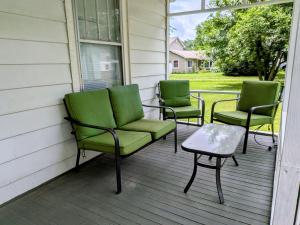 three chairs and a table on a porch at Hook Wine and Sinker in Marion