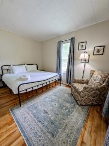 a bedroom with a bed and a couch and a chair at Hook Wine and Sinker in Marion