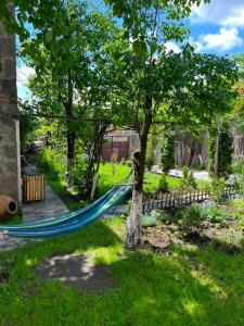 a blue hammock hanging from a tree in a yard at Narek B&B in Goris
